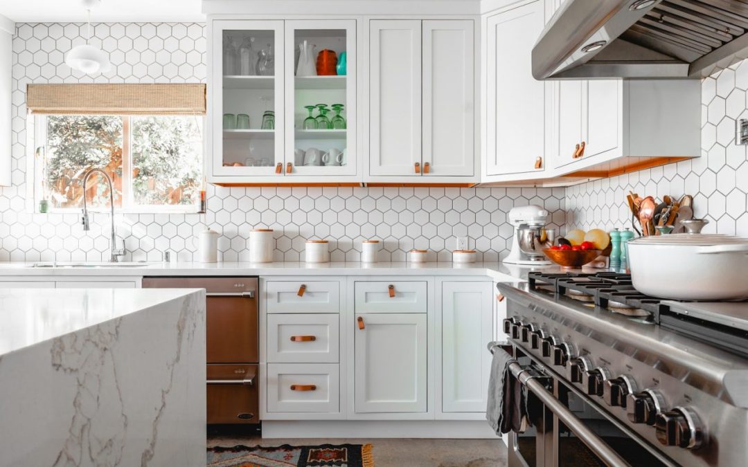 Expertly painted kitchen cabinets featuring white upper units and a grey island in Matthews.